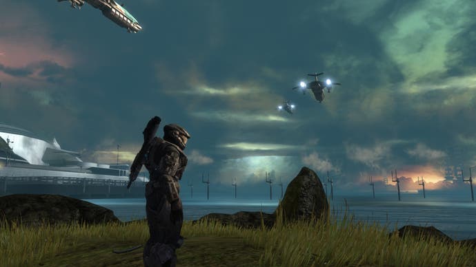 A Spartan stands in profile before a scene of planetary destruction in Halo: Reach