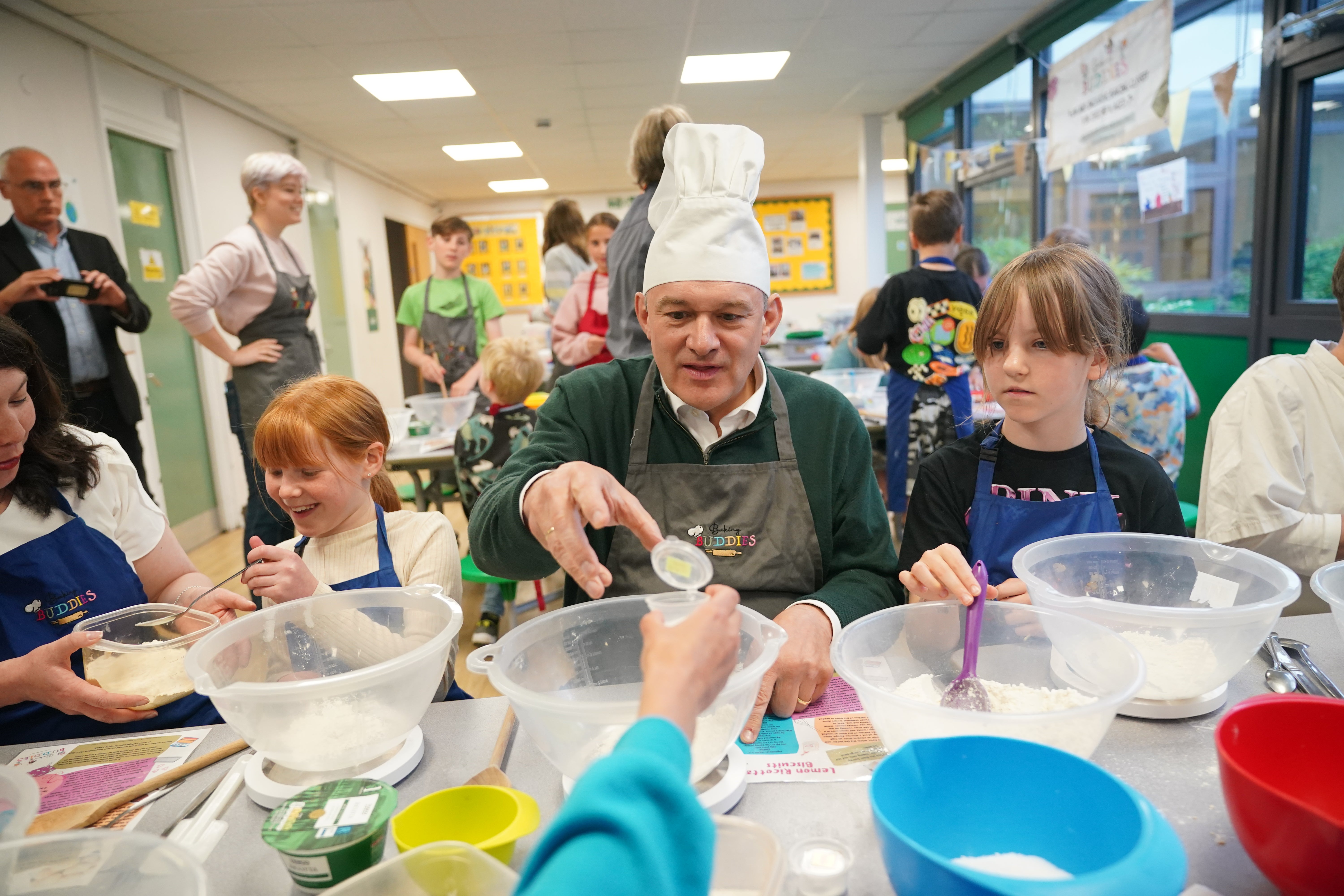 Liberal Democrat leader Sir Ed Davey takes part in a baking class with pupils from High Beeches Primary School during a six-month holiday camp in Hertfordshire as he heads to the election campaign