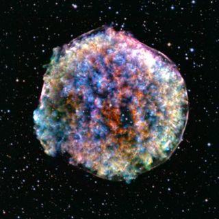 A blurry-looking, multi-colored sphere against the backdrop of space, studded with stars.