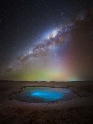 Milky Way photographed above a bright blue pool in the Atacama Desert, Chile