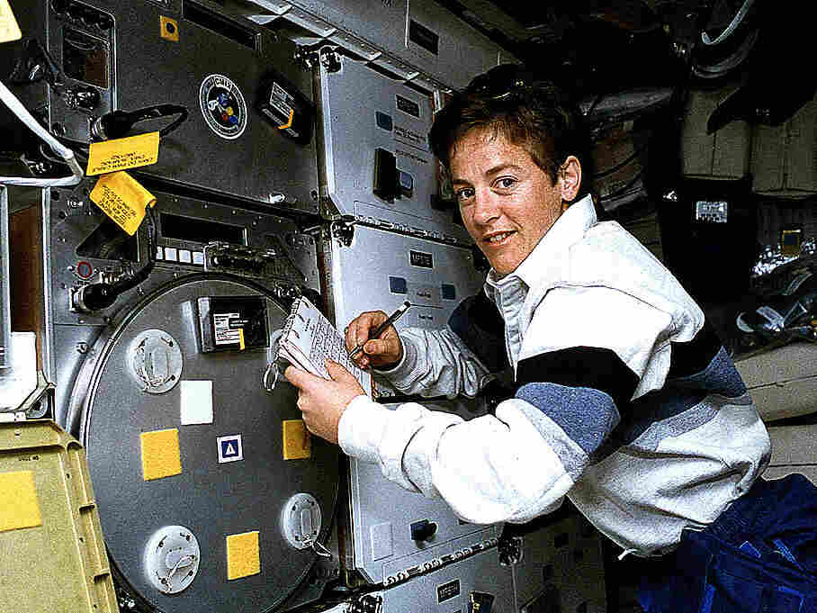 Astronaut Wendy B. Lawrence, flight engineer and mission specialist for STS-67, scribbles notes in the margins of a checklist as she monitors an experiment on the mid-deck of the Space Shuttle Endeavour.