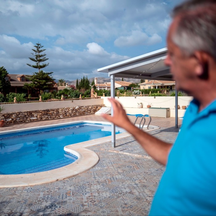 Mark Daniel, former councilor and estate agent, shows a swimming pool at a typical property a British expat will buy