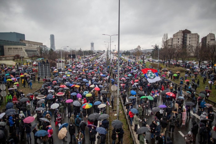 People gather to block the highway in Belgrade on December 11, 2021 to protest Anglo-Australian company Rio Tinto's plan to open a lithium mine in the country