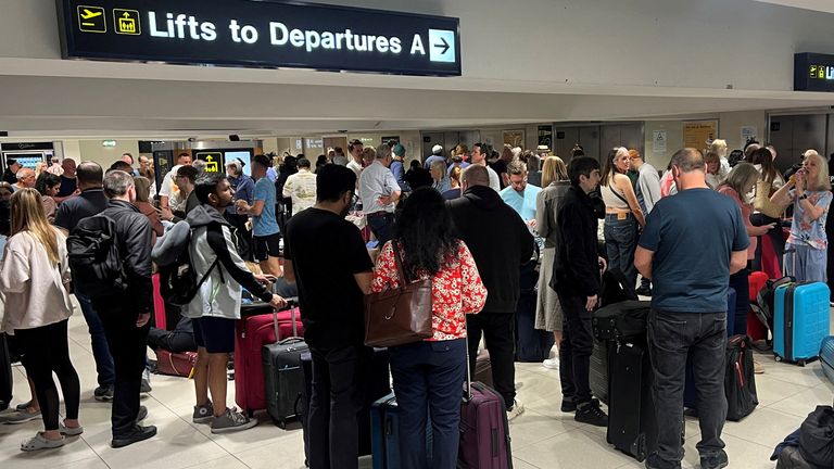 Passengers queue outside Terminal 1. Photo: Reuters