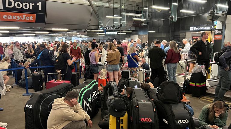 Passengers queue outside Terminal 1. Photo: Reuters