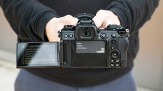 Nikon Z6 III camera in hand, rear with fold-out touchscreen