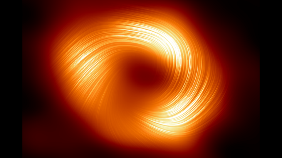 A bright orange ring with bright swirls of light in it against a dark background