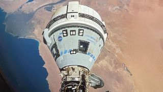 Boeing's white and blue Starliner spacecraft docked with the International Space Station in June 2024.