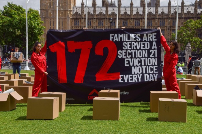 Protesters hold a banner reading '172 families receive eviction notices under Article 21 every day'