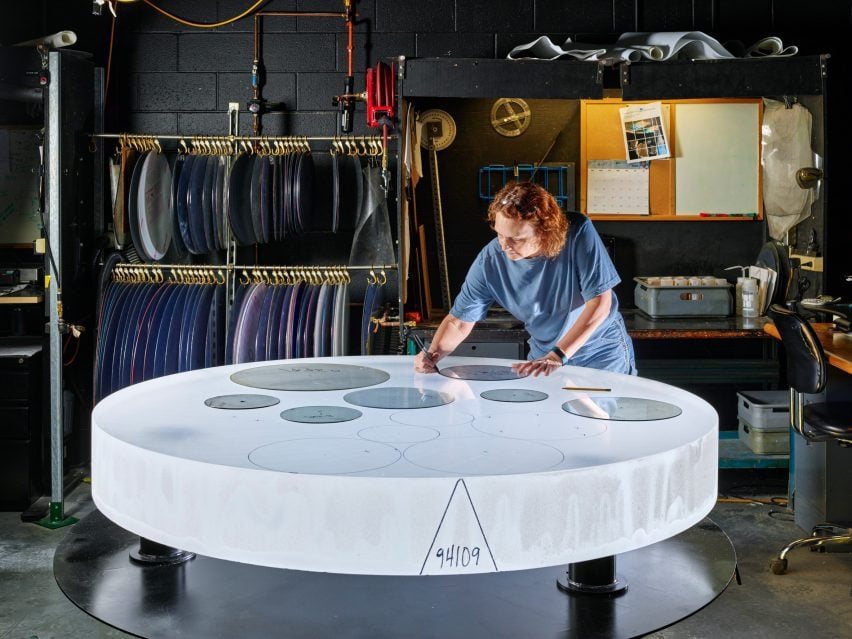 An experienced technician draws a part template for optimal glass use on a sphere of Corning HPFS Fused Silica. 