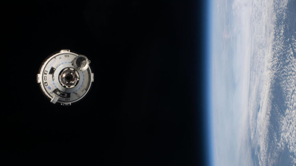 a cone-shaped spacecraft in space with the Earth visible on the left