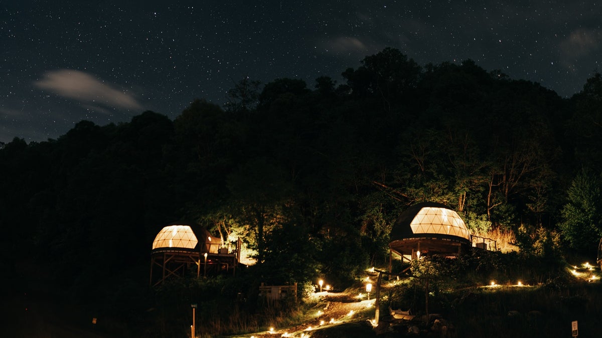 The Glamping Collective resort in North Carolina is lit up at night. 