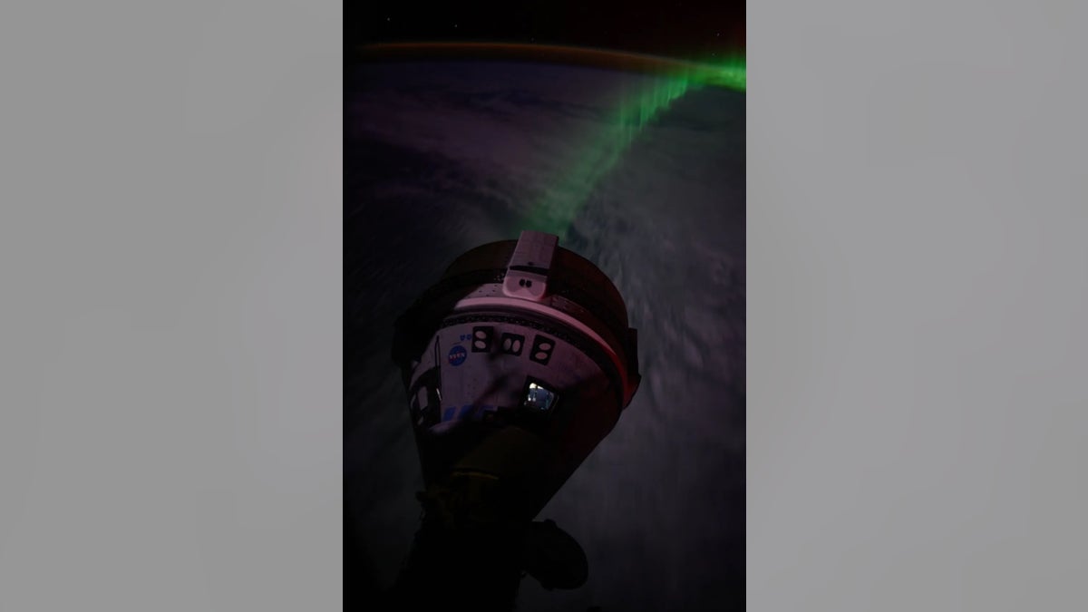 "An aurora glows beneath Boeing's Starliner spacecraft, docked at the forward port of the Harmony module, as the International Space Station floats 262 miles (428 kilometers) above the Indian Ocean, southwest of Australia." according to NASA.