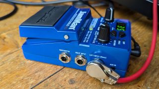 A DigiTech JamMan Solo HD looper pedal with a patch cable connected