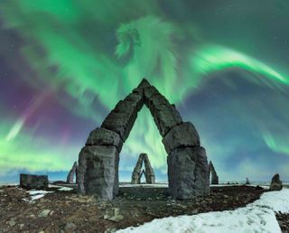 Dragon-shaped aurora above arctic henge.