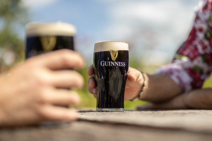 Customers drink pints of Guinness in a Sussex pub