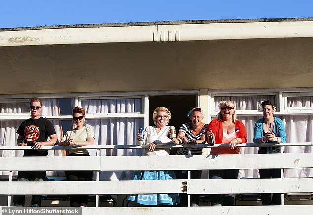 A group of partygoers on the balcony of a chalet during the Rockabilly Weekend at Pontins, Camber Sands, East Sussex, in June 2013