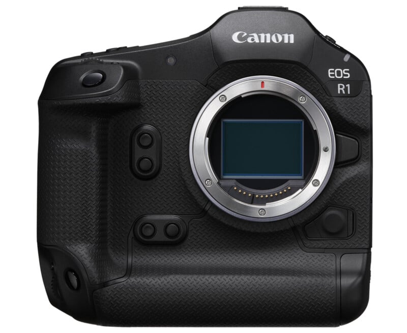 A Canon EOS R1 camera body with a black textured grip, prominent buttons and a silver lens mount without a lens. The camera has a sleek and robust design, suitable for professional photography use.