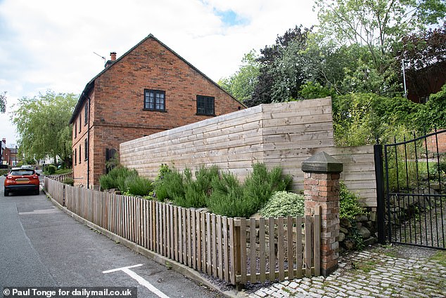 Mr Hubbard has spent thousands of pounds clearing the garden and installing a standard 8ft fence to give his family some privacy and reduce litter.