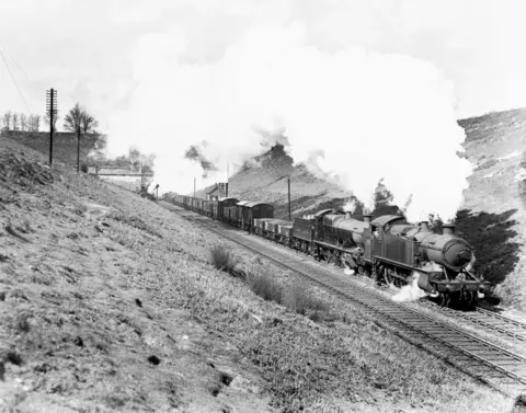 Getty Images A black and white photograph of a steam engine emerging from the eastern English end of the River Severn