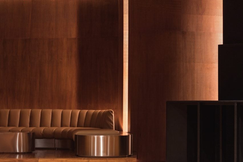 The built-in leather chairs match the warm brown tones of the wood paneling