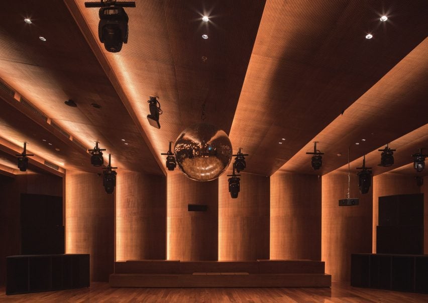 A disco ball of one meter in diameter hangs above a sprung dance floor