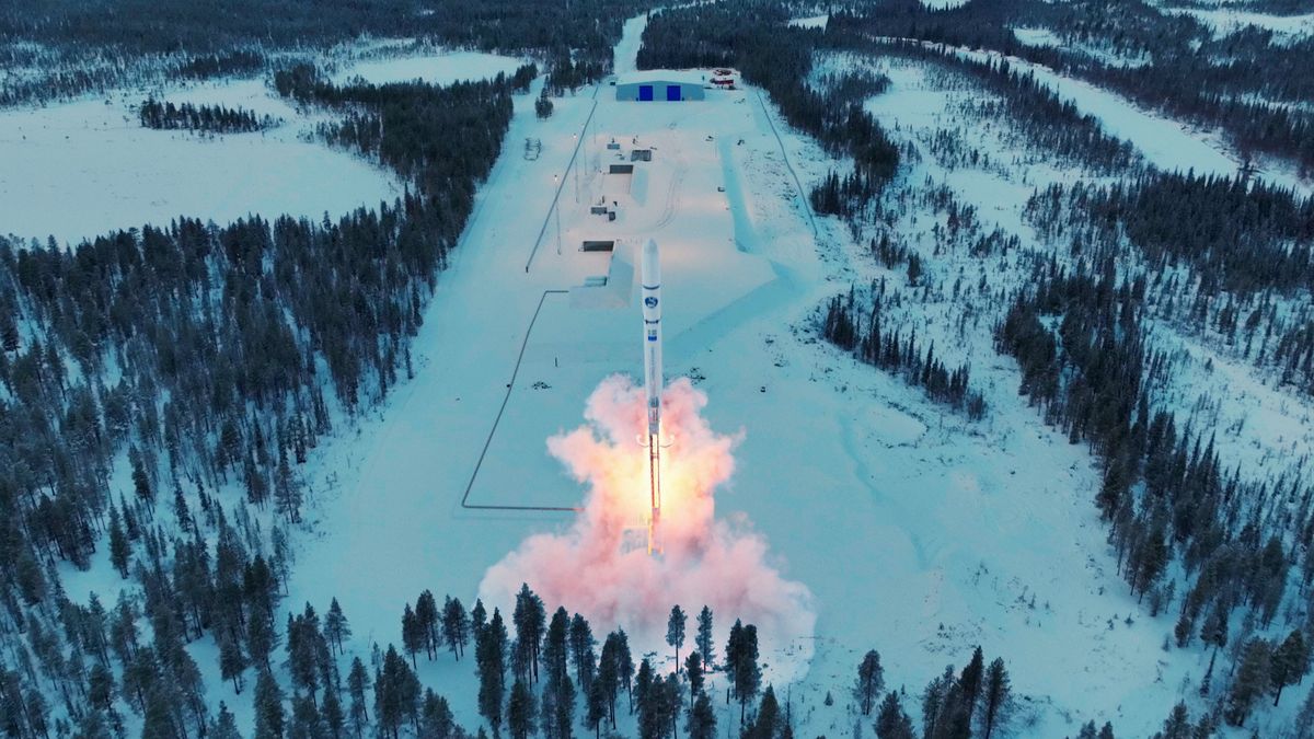 Done photo over launch site at SSC with added rocket launch animation. A snowy landscape filled with trees surrounds the snowy launch site.