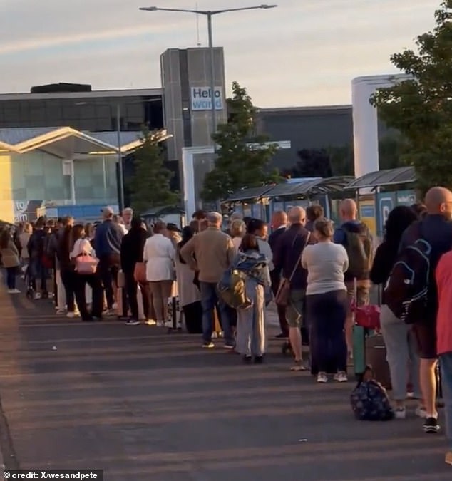 Long queues outside Birmingham Airport are seen in a video posted on X on Sunday