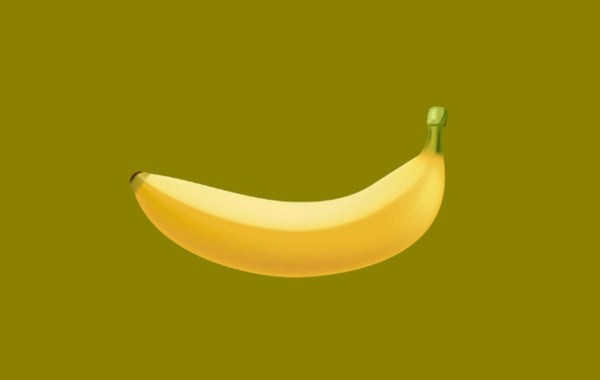 A banana on a mustard yellow background